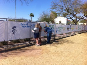 Vickie, Ed, and K.D. painting the fence at the Blues Blast